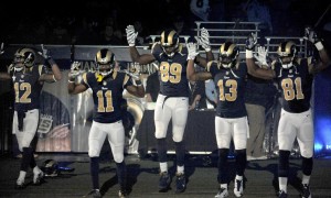 St. Louis Rams players with their hands up