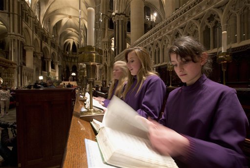 Members of Canterbury Cathedral Girls' Choir look at hymnals in preparation for their debut