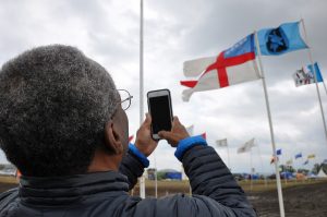 The Presiding Bishop takes a photo of the Episcopal flag at the Standing Rock protest