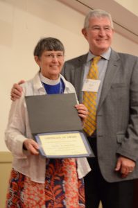 Lisa Kirby, president of Recovery Ministries of the Episcopal Church, presents Stuart Hoke with the Samuel Shoemaker Award at the annual meeting of RMEC in November